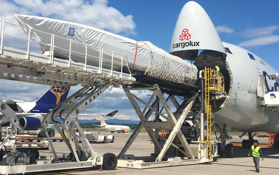 Boat raised on a loader and pushed into the nose of a 747 freighter