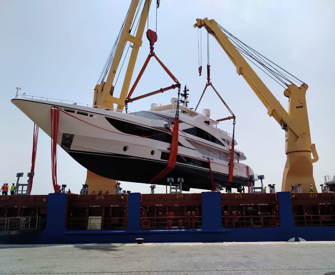 Motor yacht lifted by ship cranes with soft slings during yacht transport to Bahrain