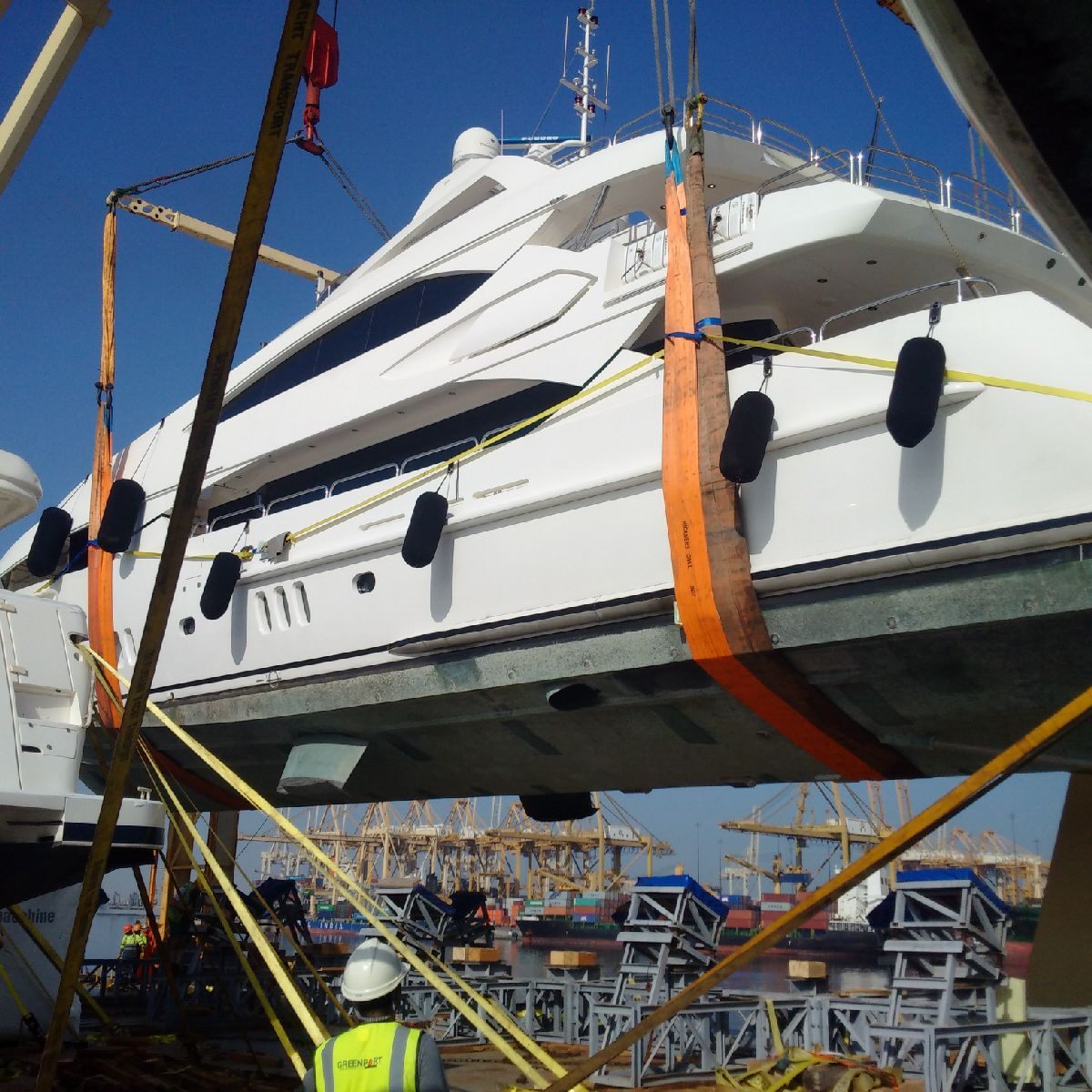 Motor yacht being lifted off a cargo ship with soft slings on arrival in Phuket