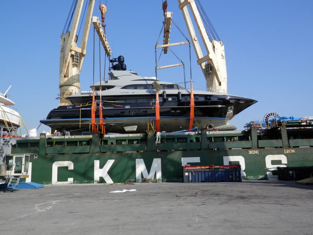 Yacht loaded on the deck of a heavy lift ship for transport to Qatar