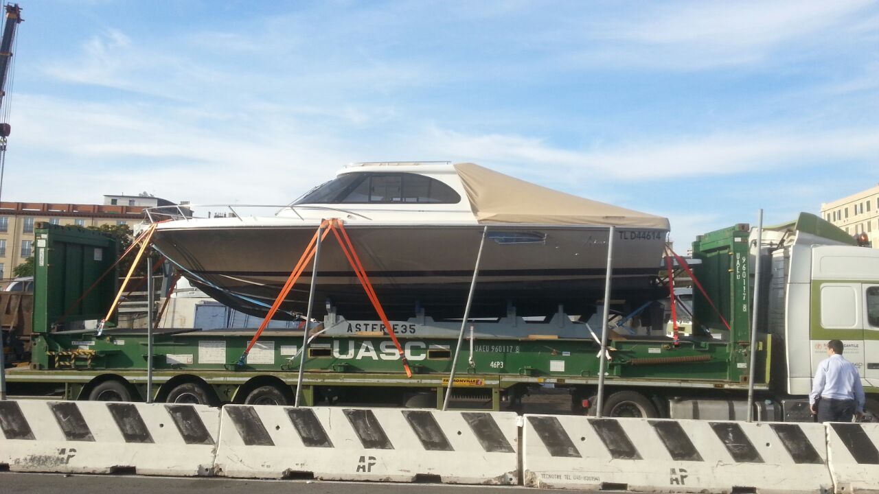 Yacht on a flatbed truck prepared for road transport from the UAE to Qatar