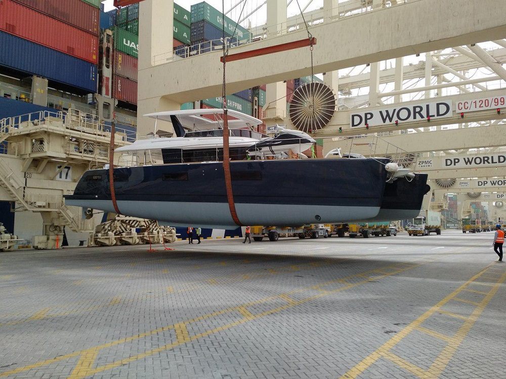 Yacht lifted onto a cargo ship at Jebel Ali for transport to Saudi Arabia