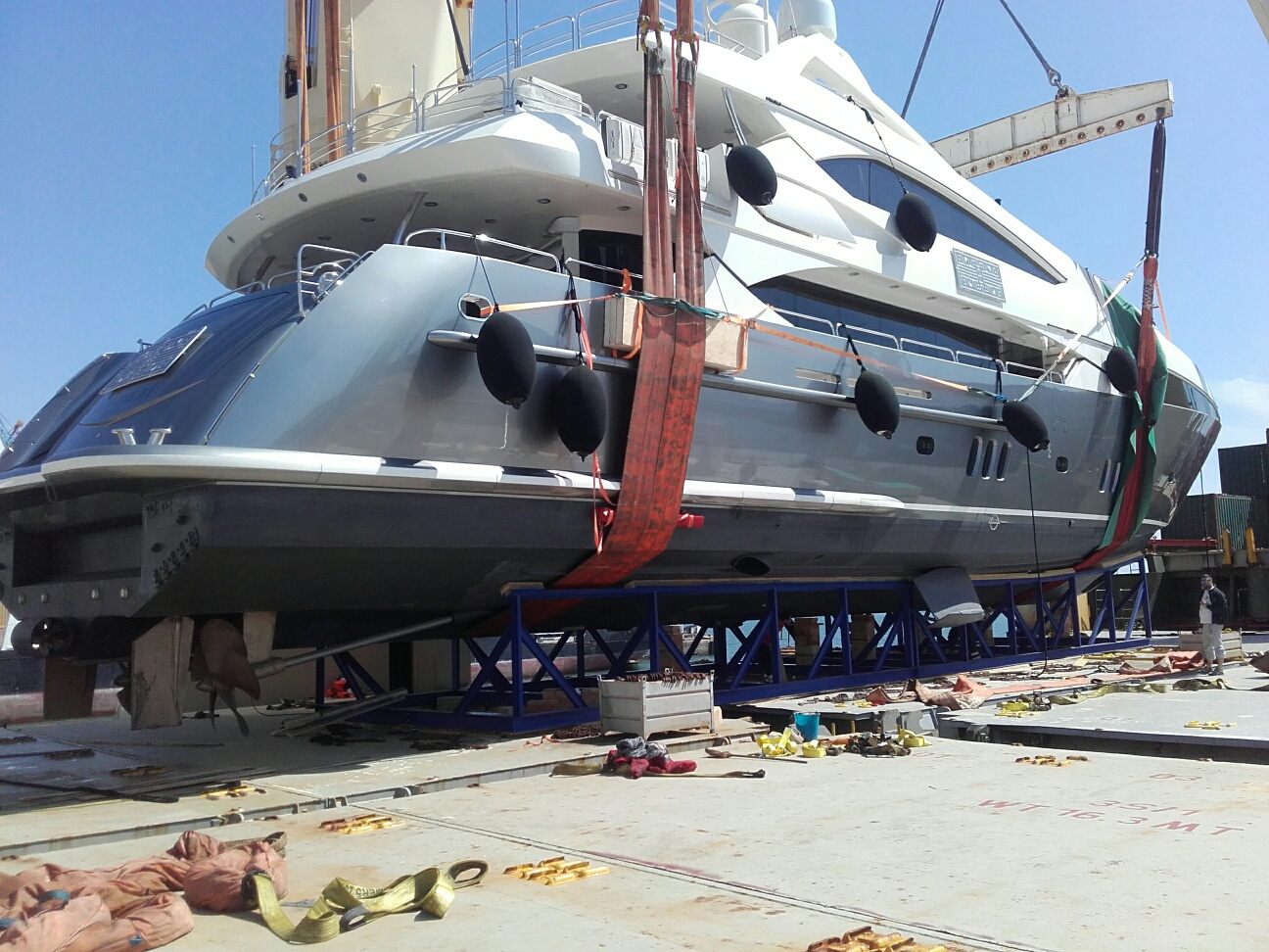 Superyacht secured on its cradle on the deck of a cargo ship for yacht transport to Thailand