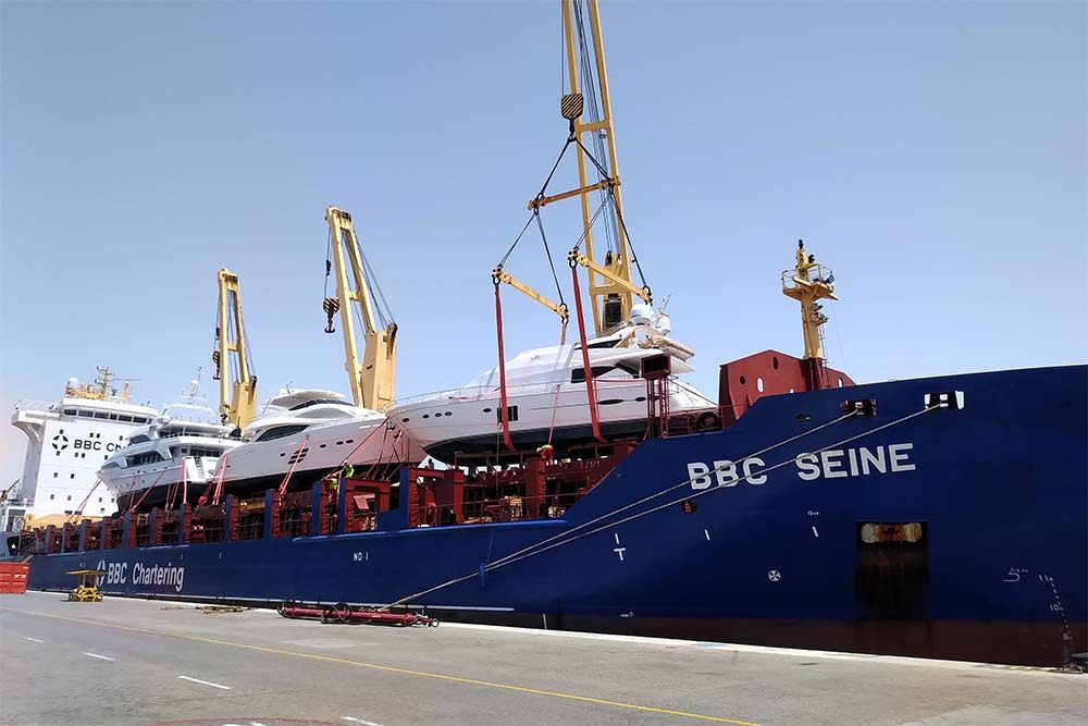 Yachts loaded on the deck of a cargo ship for transport to Thailand