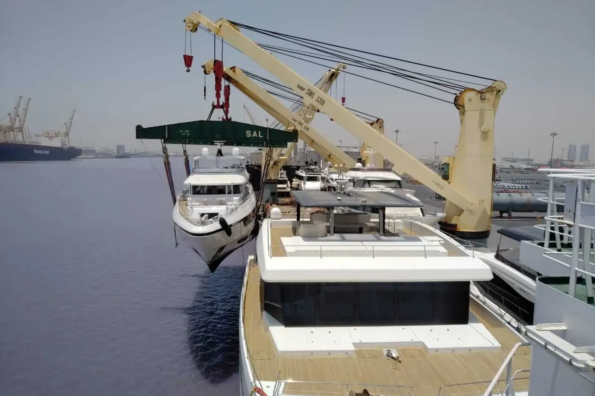 Yacht lowered from a cargo ship straight into the water at discharge