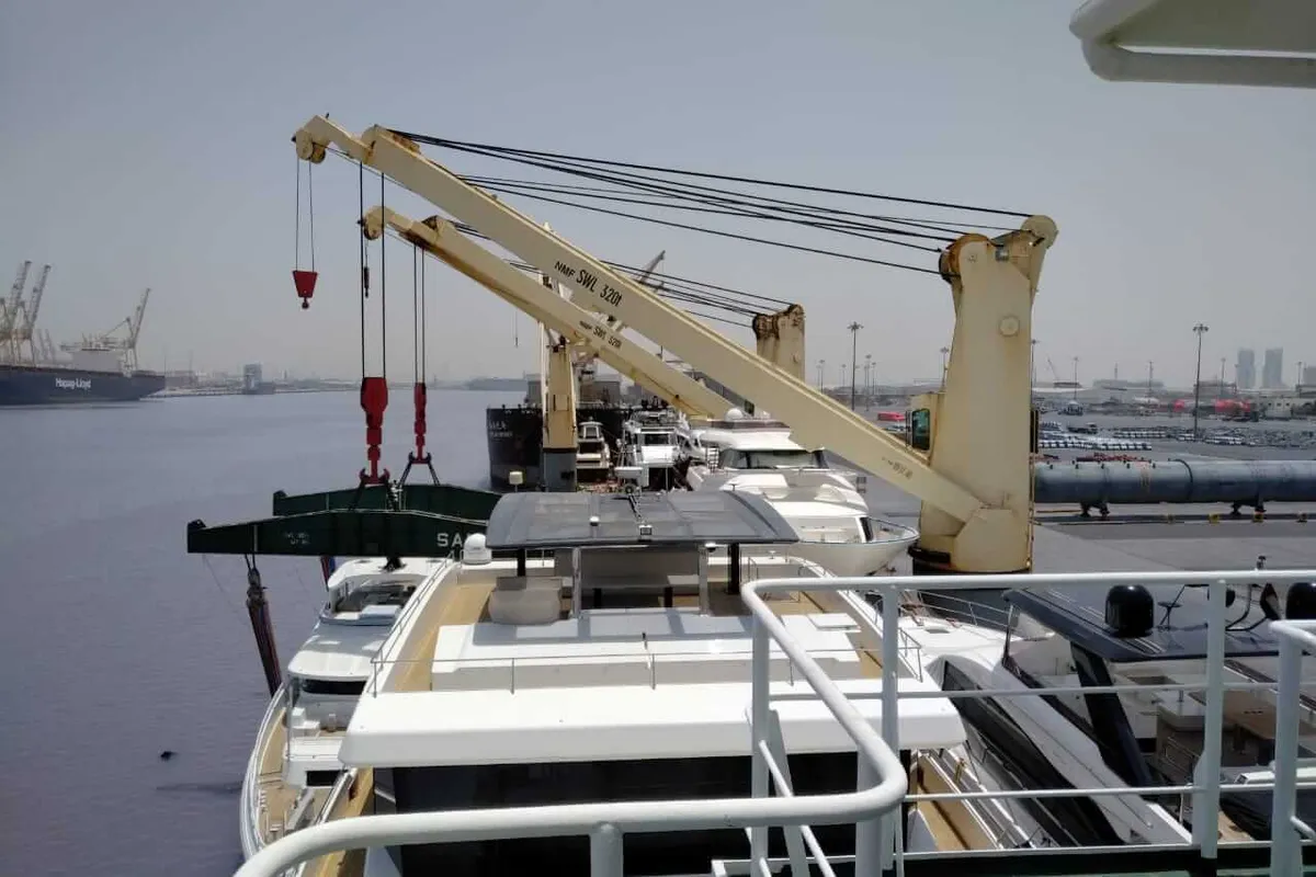 Yacht lowered from the ship into the water at the port of discharge