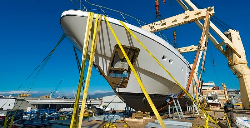 Bow of a superyacht in slings during loading