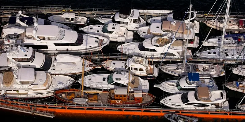 Aerial view of many motor and sailing yachts carried together on a ship's deck